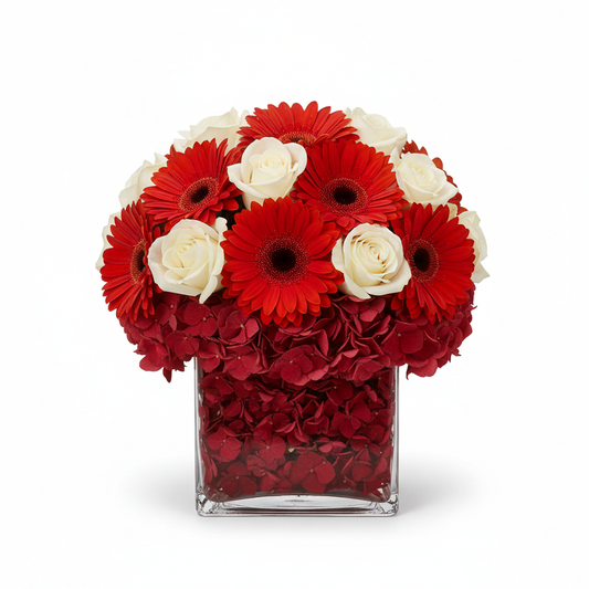 cube vase mixture of red gebera, red hydrangia base with white roses